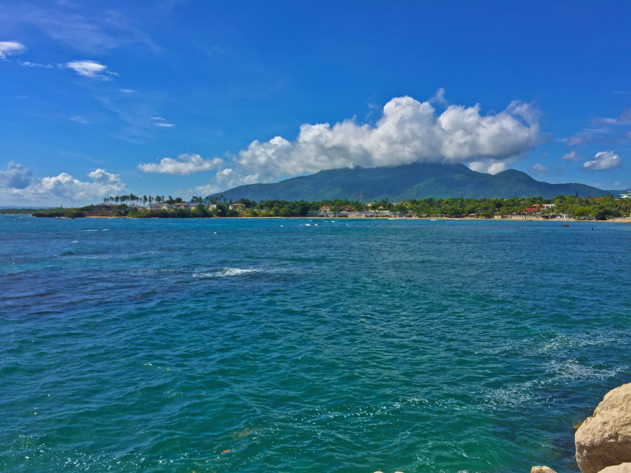 Ocean with mountain in background in Puerto Plata