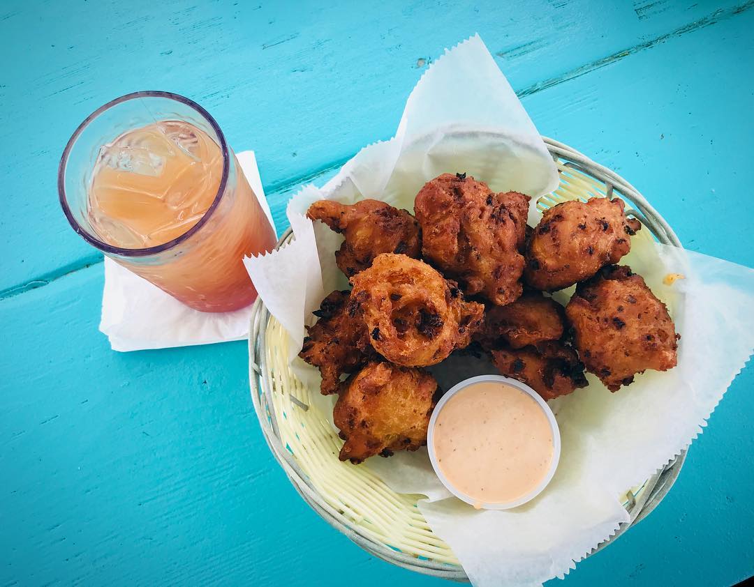 Fried conch in basket on blue table. 