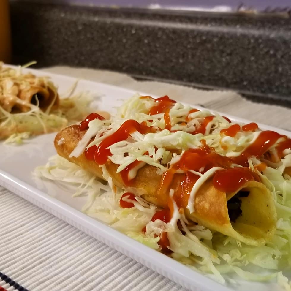 Fried tacos served on platter. 