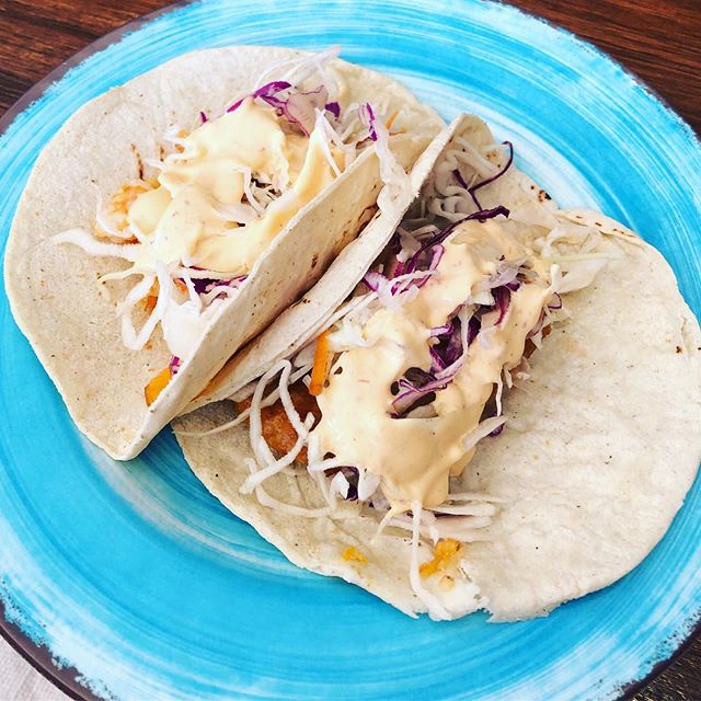 Baja shrimp tacos served on blue plate. 