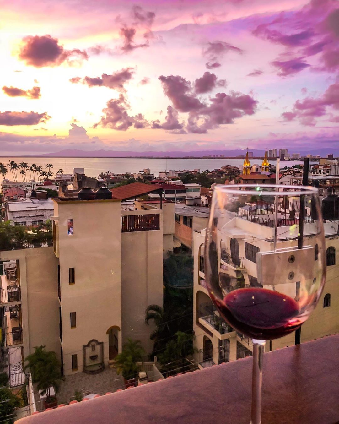 Balcony view with a glass of red wine.
