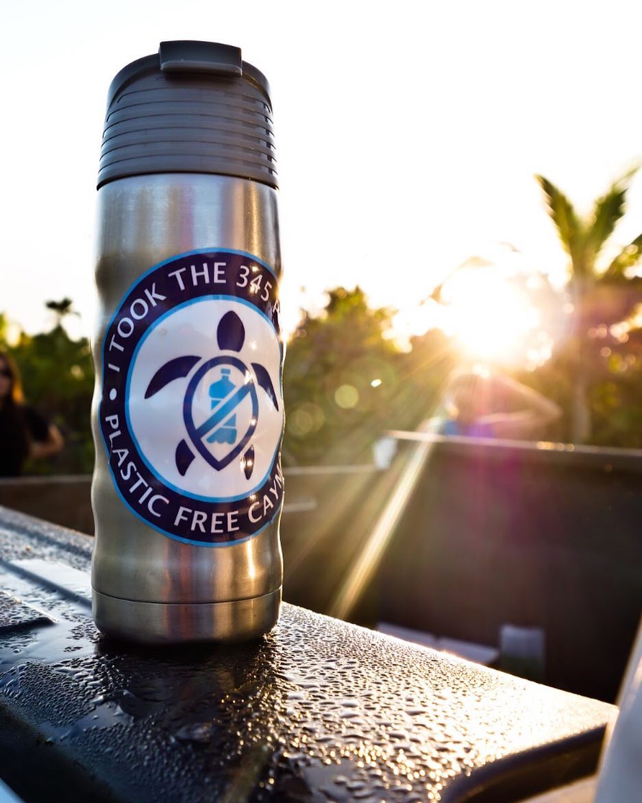 Water bottle on ledge with turtle sticker on it. 
